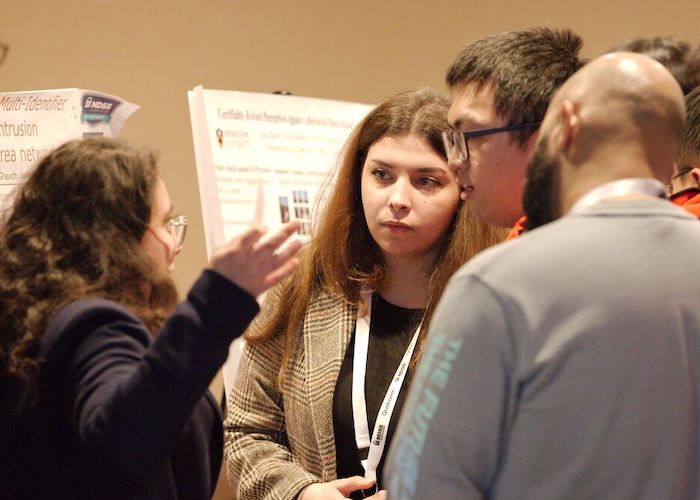 a lady explaining something while three people listening to her