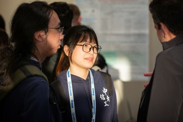 a woman and two men engaged in a conversation