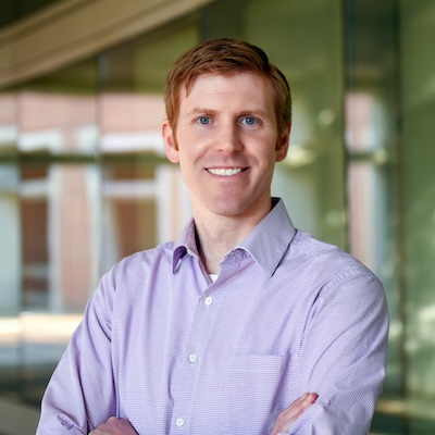 a man wearing a purple shirt